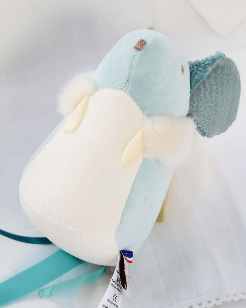 Plush toy with a label on a light background