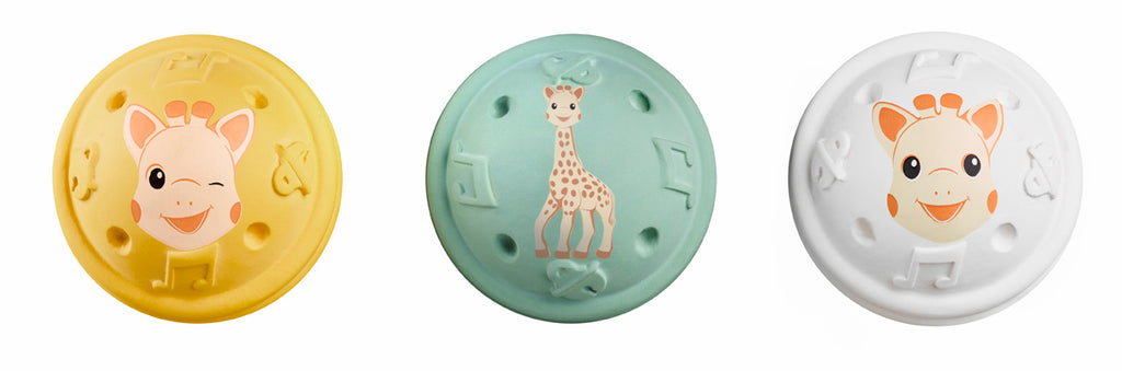 3 sophie the giraffe musical balls in yellow, green, and white