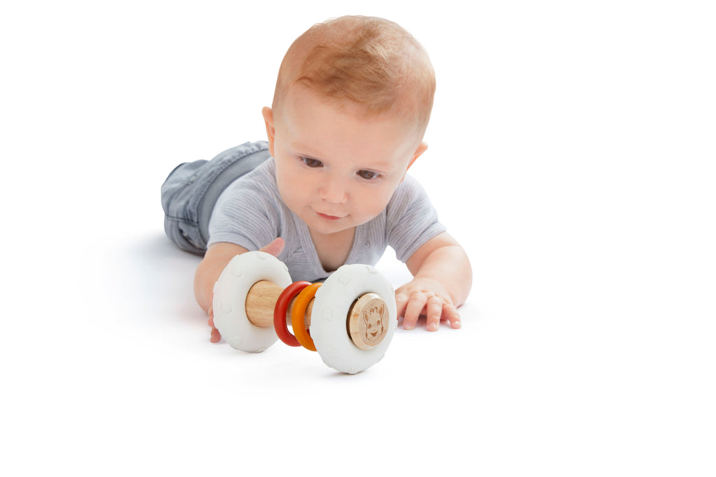 Baby playing with sophie so'pure totem rattle