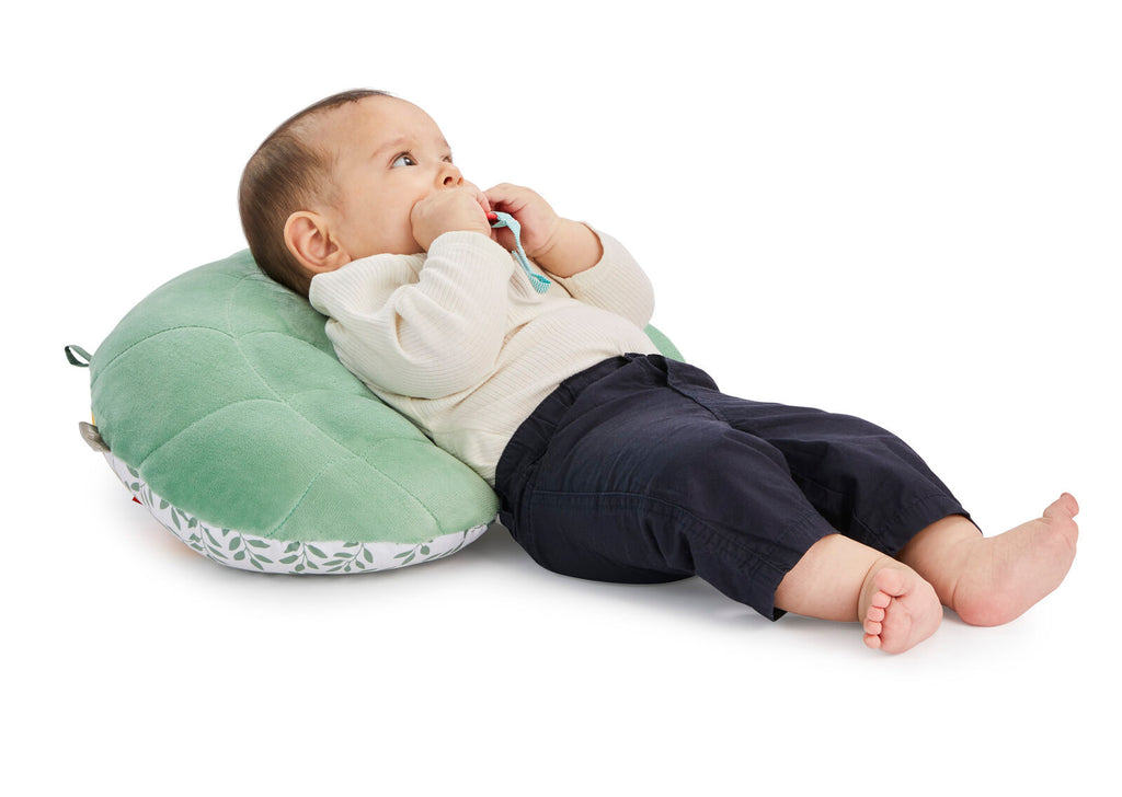 Baby resting on sophie cosy play cushion