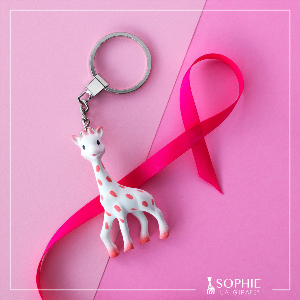 Pink sophie the giraffe keychain with breast cancer awareness ribbon and background