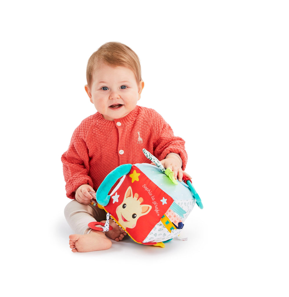 Baby playing with sophie the giraffe sensory cube