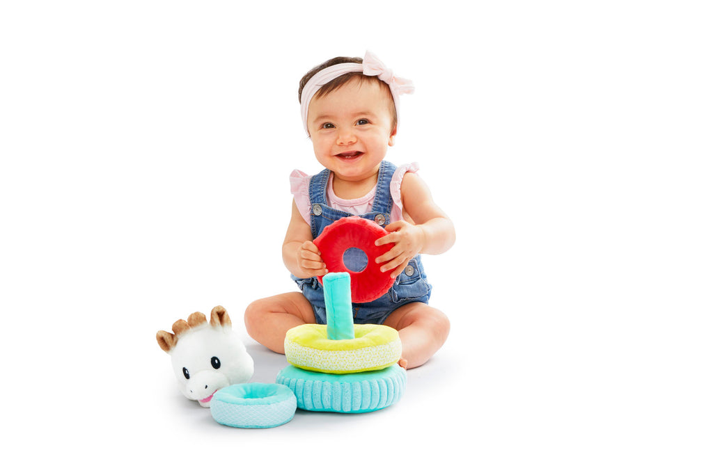 Laughing baby playing with sophie sweet stacking pyramid