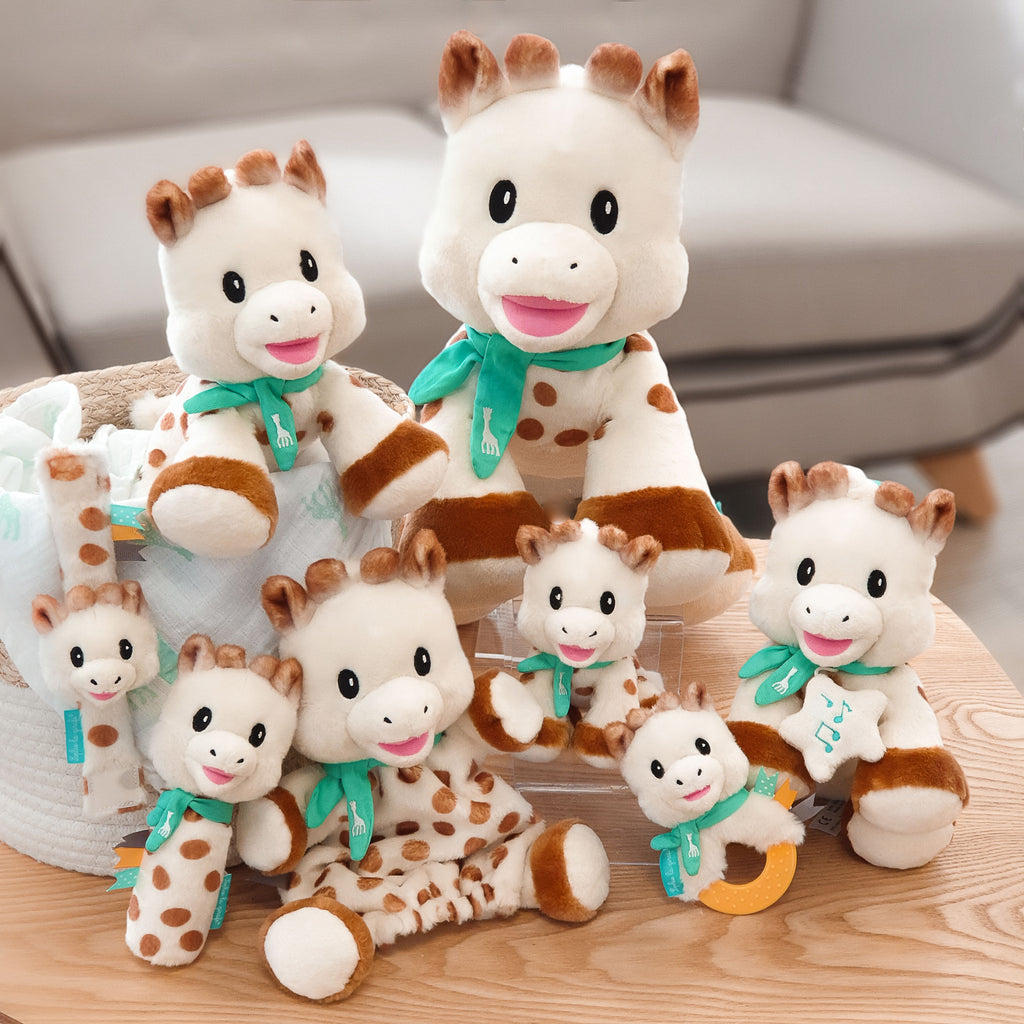 Collection of sophie the giraffe "sweetie" line including 3 sizes of the sweetie plush, music toy, puppet, rattle, and teether for babies and toddlers