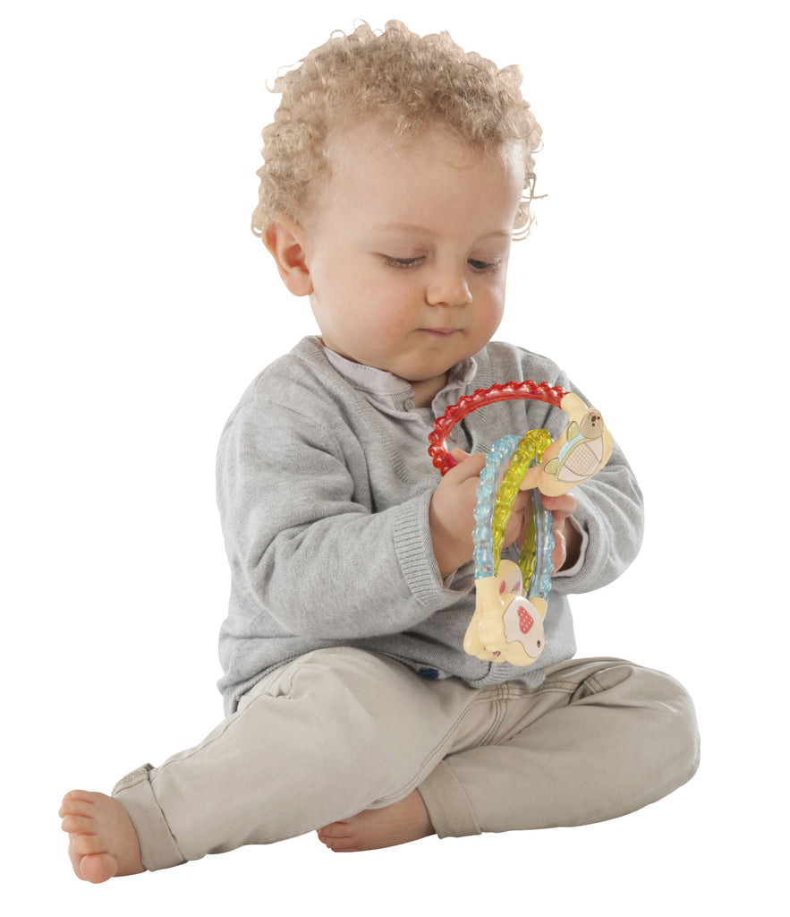 Baby playing with sophie trilogy rattle